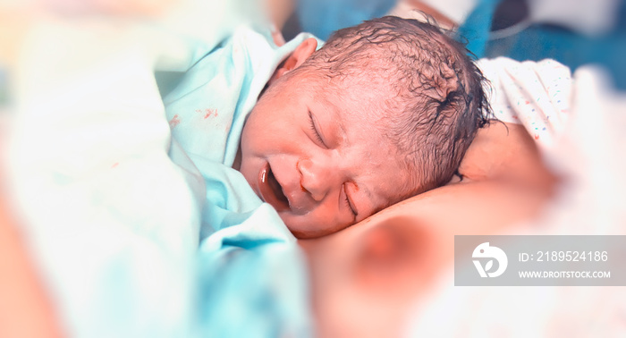 Mother and infant child resting after delivery at hospital, newborn and mother in hospital. First to