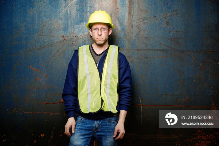 Industrial worker standing in front of wall