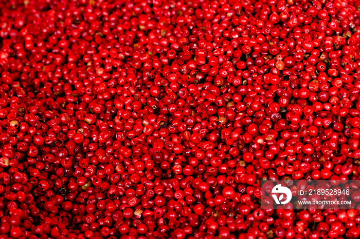 Pink (red) pepper peas top view, background.