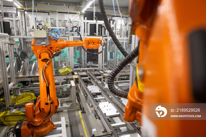 Automatic robots in the industrial factory for assembly automotive products, automotive concept