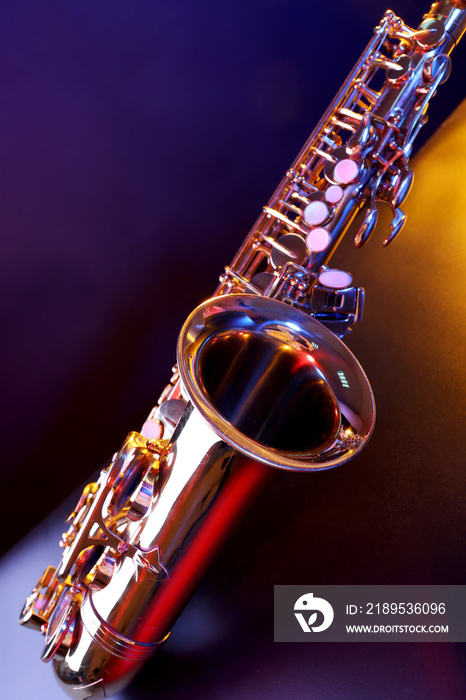 Golden saxophone on purple background