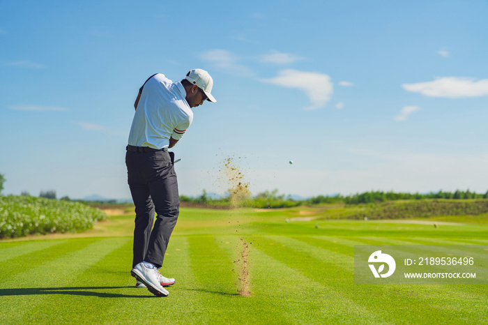 Asian man golfing on the course in summer