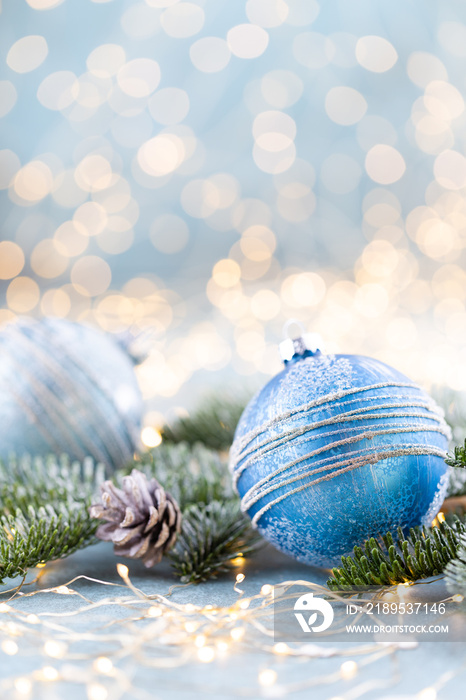 Christmas spruce with ball and blurred shiny lights.