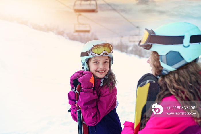 teen friends laugh on a winter day on the ski slope