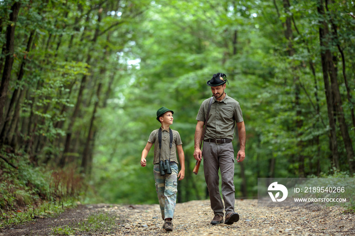 Ranger and his son in the woods