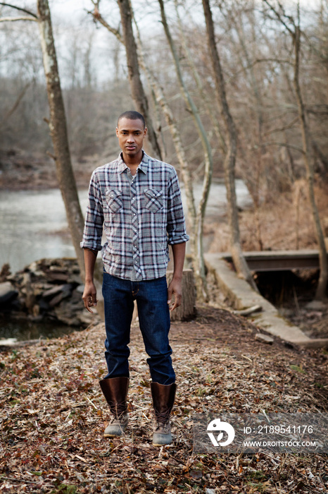 Portrait of man standing in forest