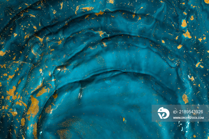 Abstract paint texture art. Natural luxury. Blue paint with gold glitter powder. Marble background.