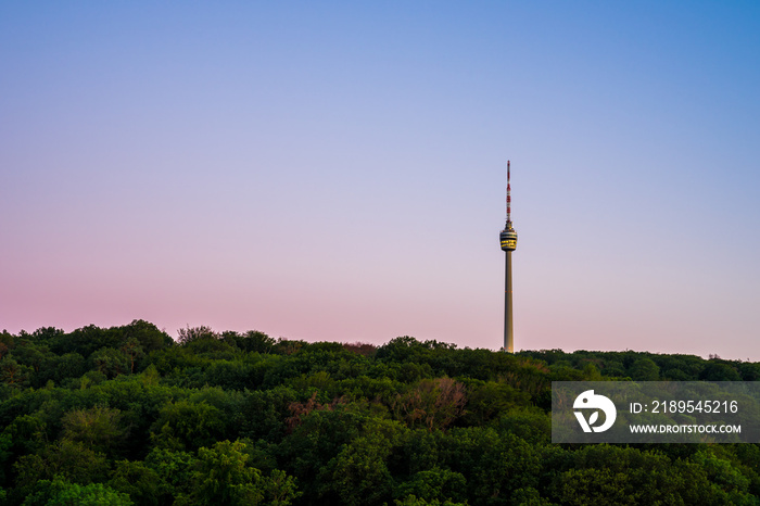 Germany, Illuminated famous television tower of stuttgart city inside endless green forest of trees 