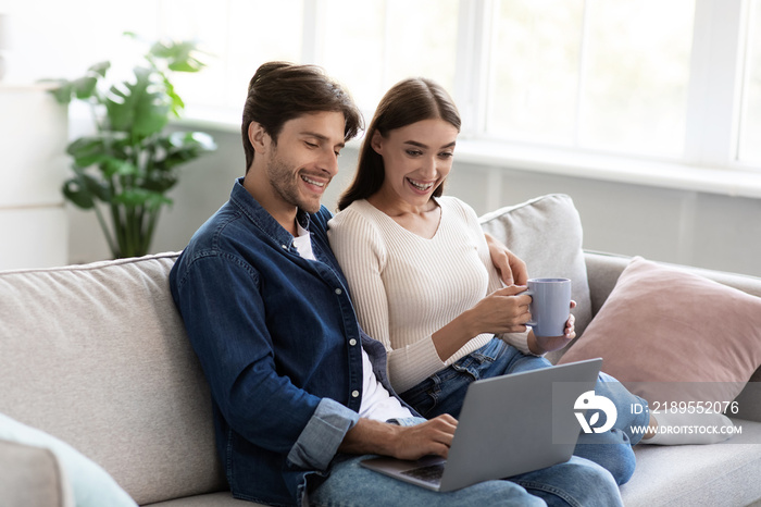 Cheerful millennial european husband and wife spending free time and weekend together, looking at la