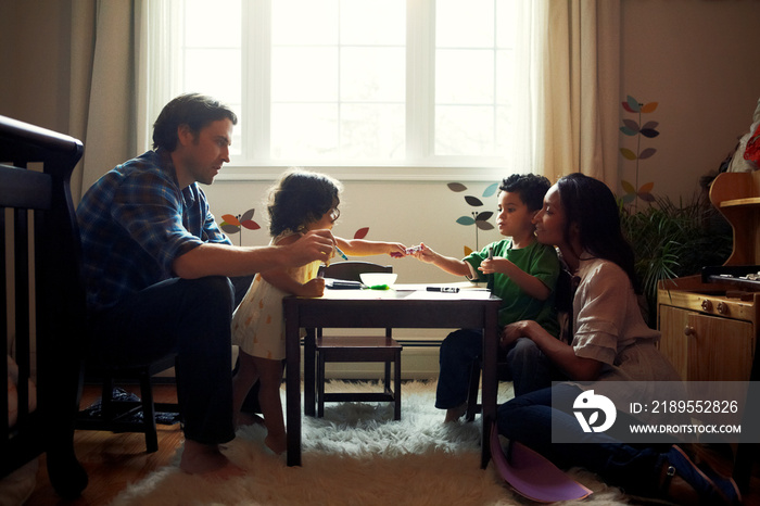 Family with two children (18-23 months) spending time together at home