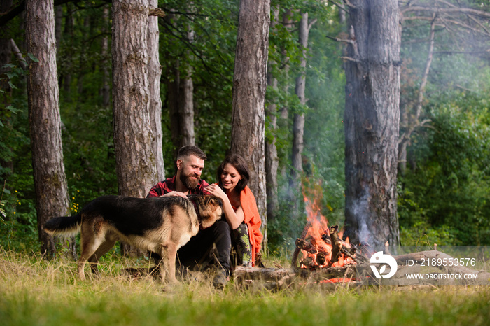 Woman, man and dog on vacation, hiking, camping.