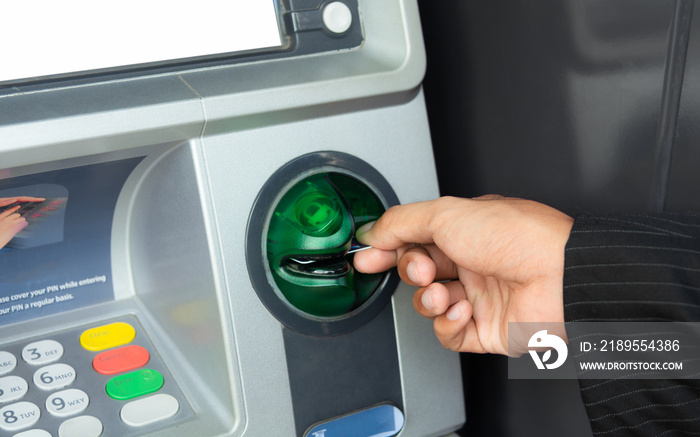 Close-up Of Person Using Credit Card To Withdrawing Money From Atm Machine