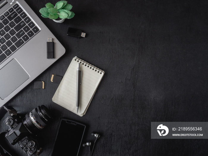 top view office table concept with coffee cup, digital camera, notebook, glasses, laptop and smartph