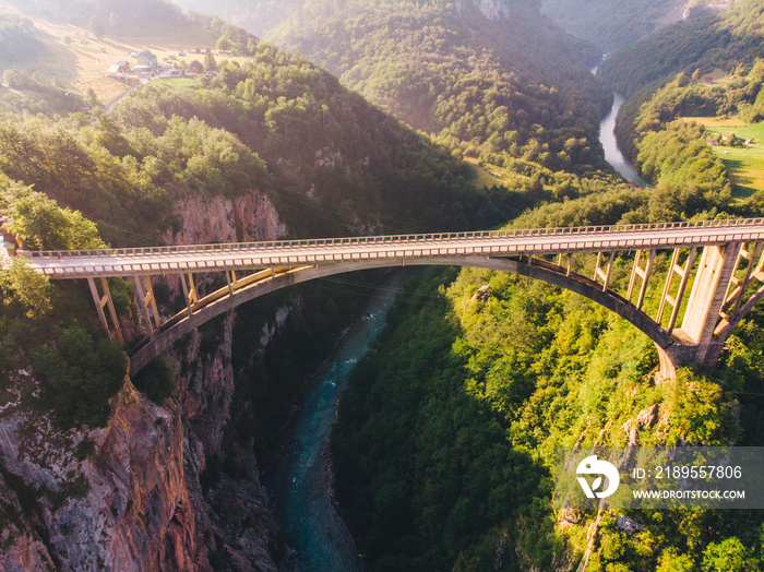 highway with high bridge cross canyon. blue clear water