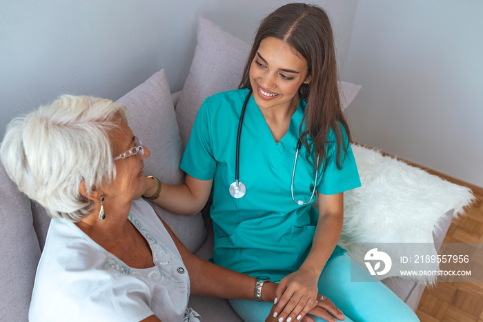 Happy patient is holding caregiver for a hand while spending time together