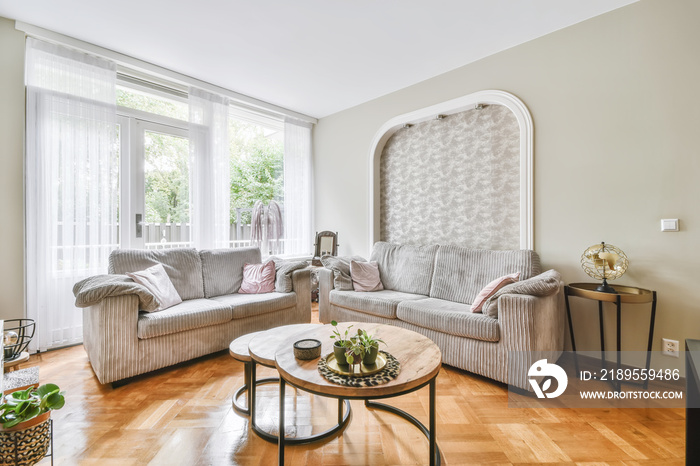 Amazing living room with gray sofas and round coffee table