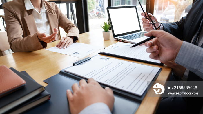 A Young Female Business women Applicant In Office Male Manager Interviewing holding resume and speak