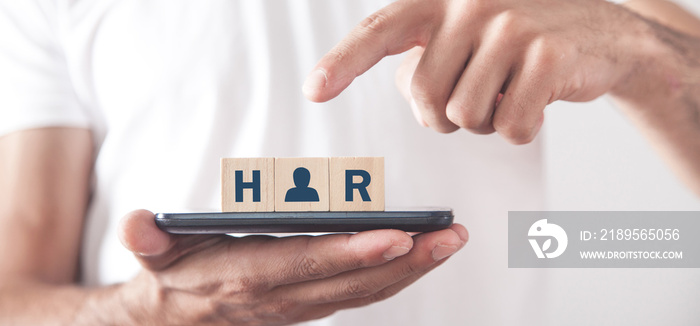 Man showing HR word on wooden cubes.