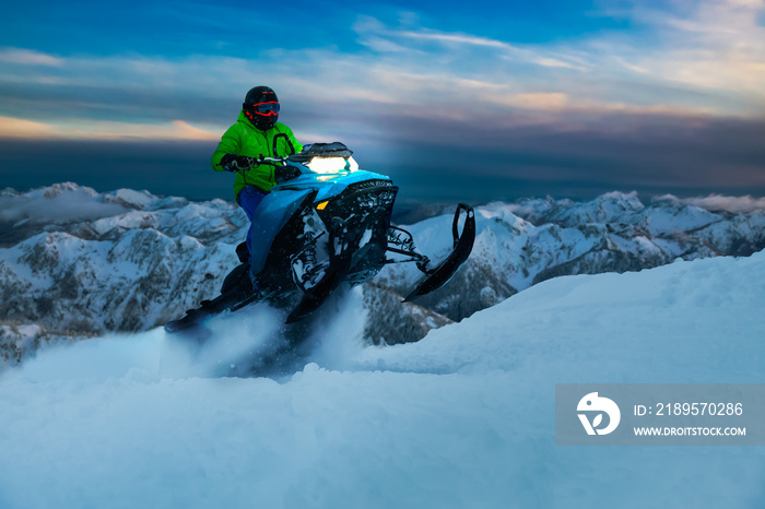 Adventurous Man Riding a Snowmobile in white snow during a colorful sunset. Epic Action Image Compos