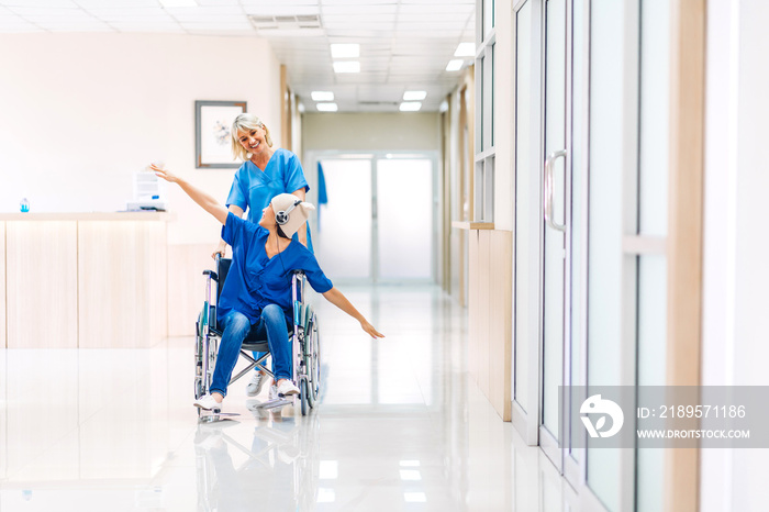 Professional medical doctor team with stethoscope in uniform discussing and dancing with happy patie