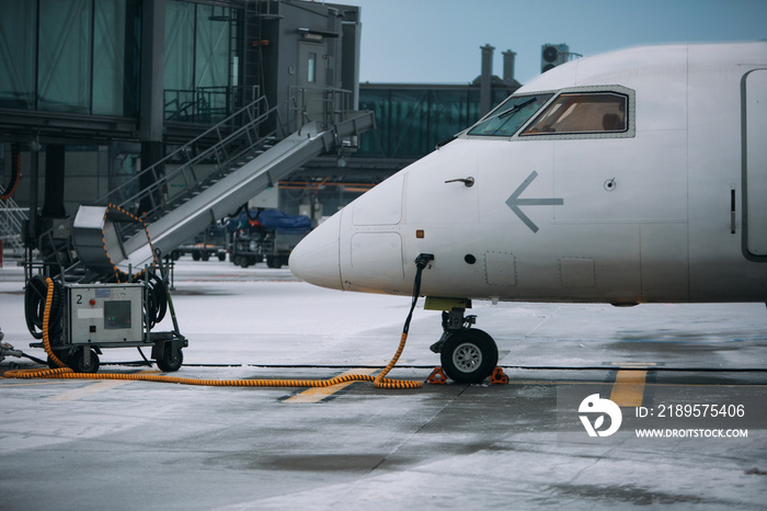 Modern airplane near terminal with GPU