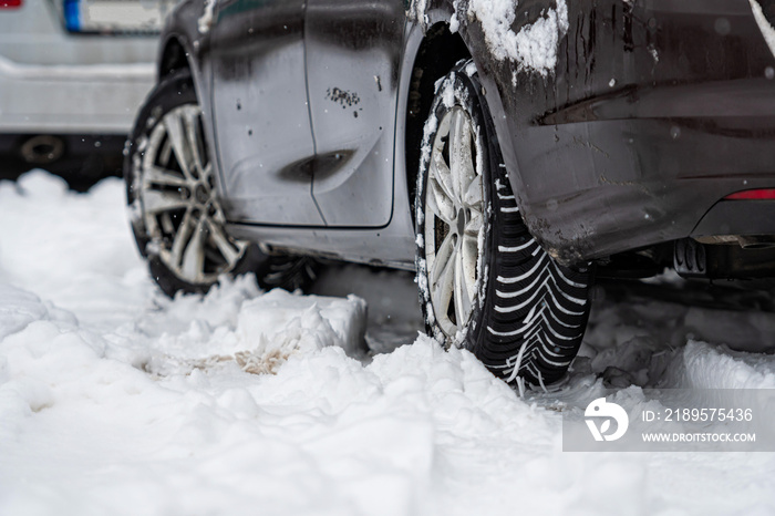 car tires on winter road covered with snow, close-up