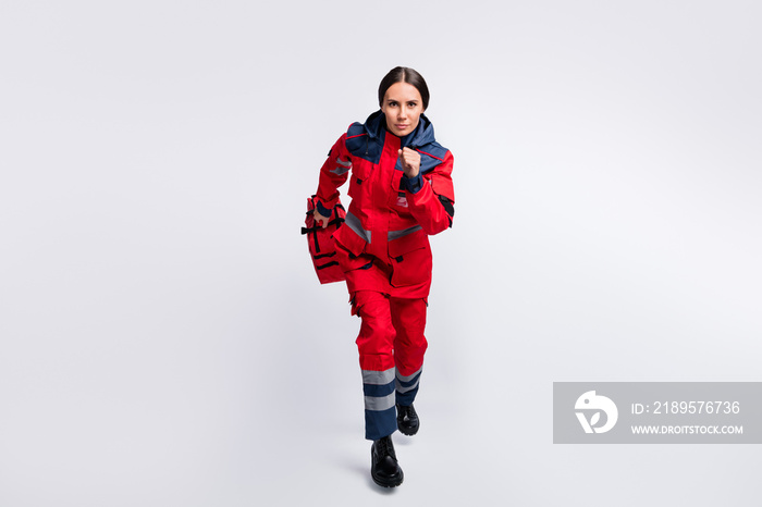 Full length body size view of serious girl skilled doc rescuer jumping running carrying meds isolate