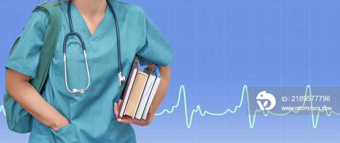 Female nurse or intern surgeon in blue uniform with books and a bag on blue background electrocardio