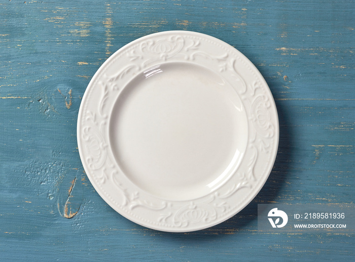 white plate on blue wooden table
