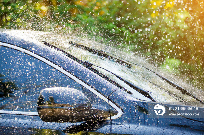 Car windshield with rain drops and frameless wiper blade