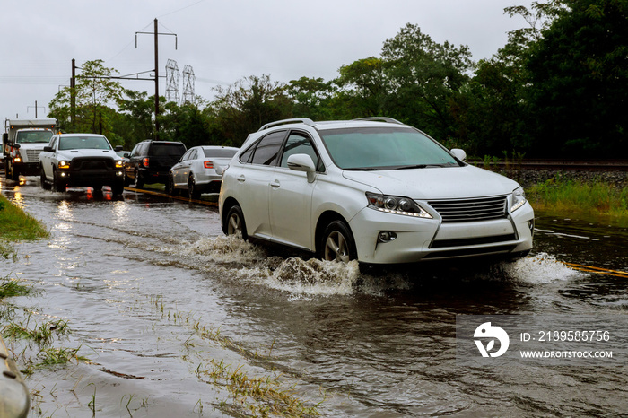 洪水大雨期间，汽车在被洪水淹没的道路上行驶，