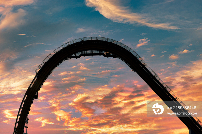 A very colorful Autumn sunset is a nice backdrop to this rollercoaster.