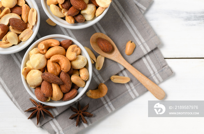 salted cocktail nuts on white wood