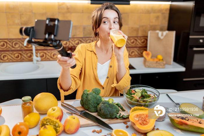 Young and cheerful woman vlogging on mobile phone about healthy food and cooking. Concept of healthy