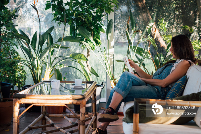 Relaxed woman reading a book in the garden