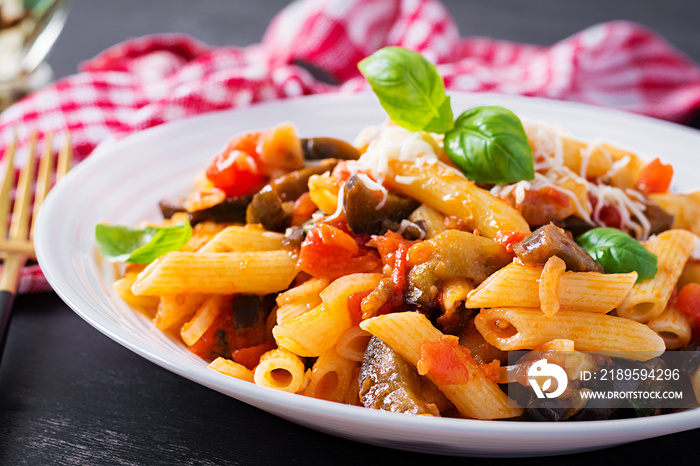 Pasta penne with eggplant. Pasta alla norma - traditional Italian food with eggplant, tomato, ricott