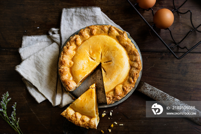 Homemade pumpkin pie with a slice cut out