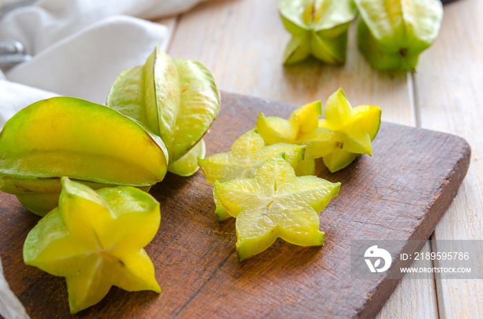 Exotic starfruit or averrhoa carambola on wooden cut board. Perfect ingredient for healthy food, veg