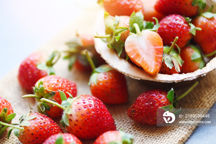 Red ripe strawberry on wooden background, Fresh strawberries on sack