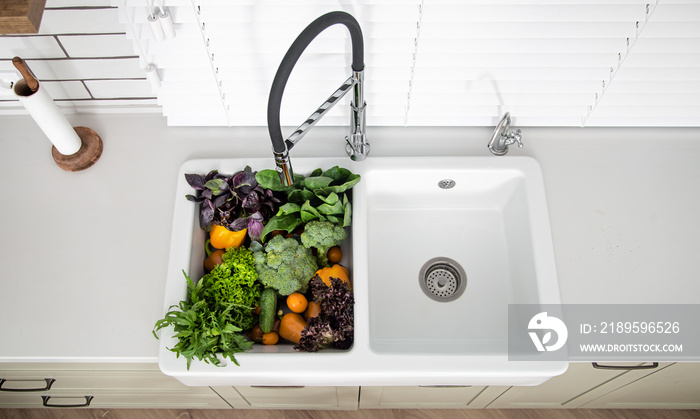 Bright washed vegetables in the kitchen sink top view.