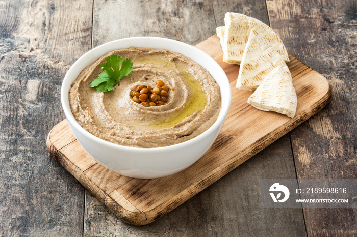 Lentil hummus and pita bread on wood