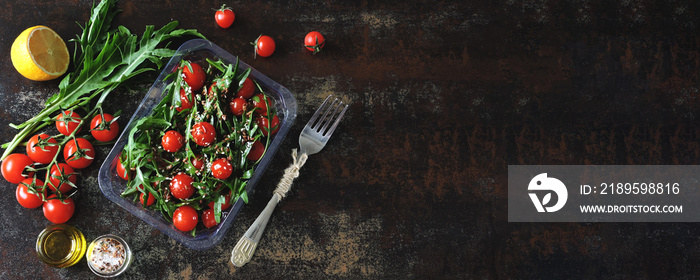 Healthy salad in the lunchbox. Arugula salad and cherry tomatoes with seeds to go. Keto diet Banner.