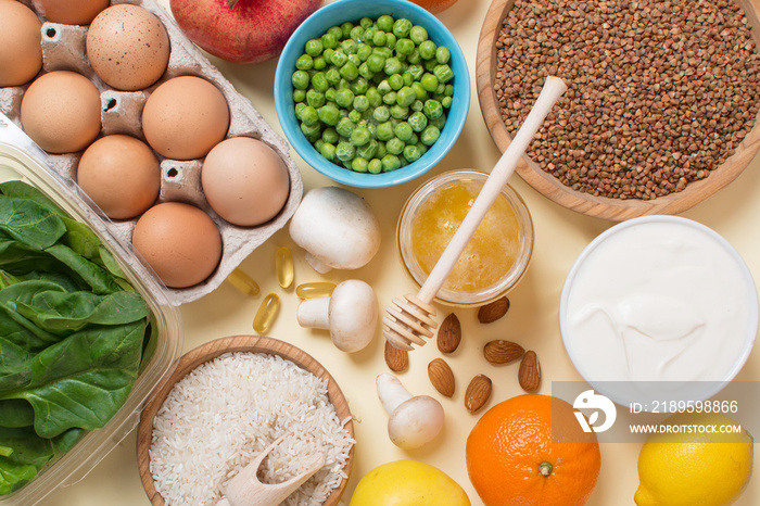 a set of useful foods and vitamins on a light yellow background.