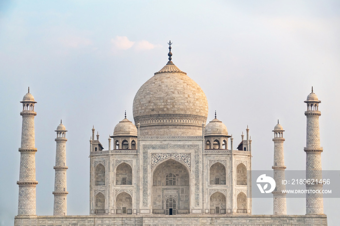 Taj Mahal front view reflected on the reflection pool, an ivory-white marble mausoleum on the south 