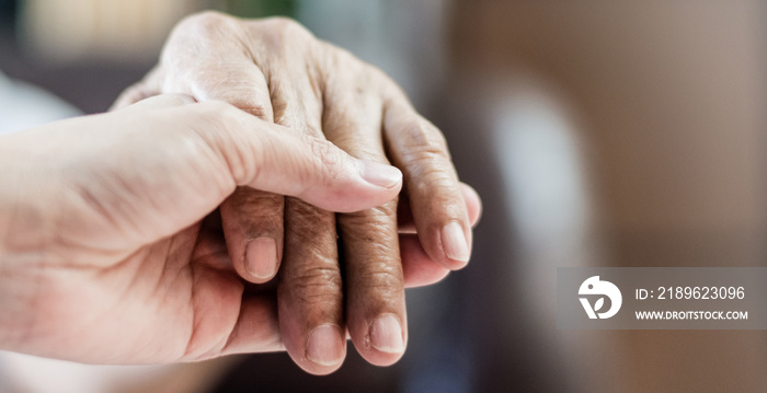 Parkinson and Alzheimer female senior elderly patient with caregiver in hospice care. Doctor hand wi