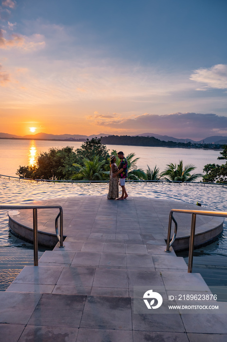 couple man and woman mid age in swimming pool on a luxury vacation in Thailand, men and Asian woman 