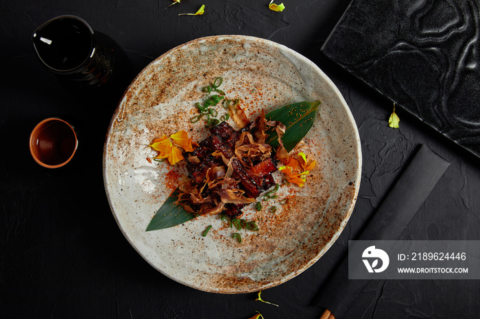 top view of delicious meat in sauce served on round plate