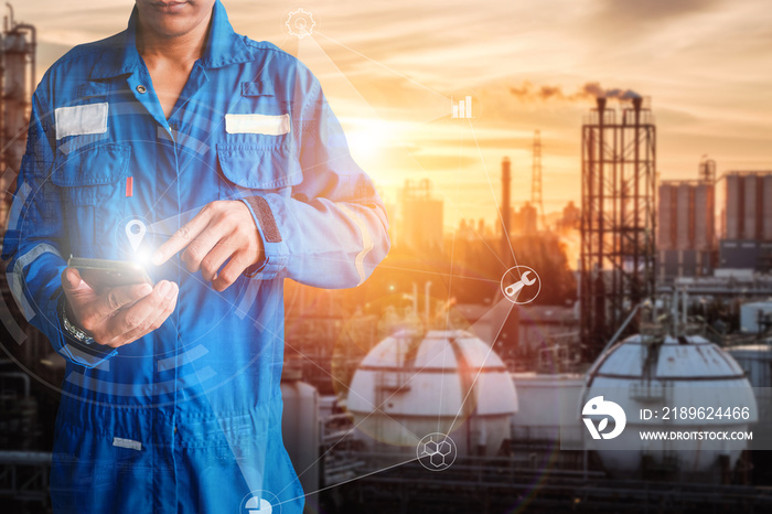 Asia engineer stand holding hand touch of smart phone on oil and gas refinery plant background, Engi