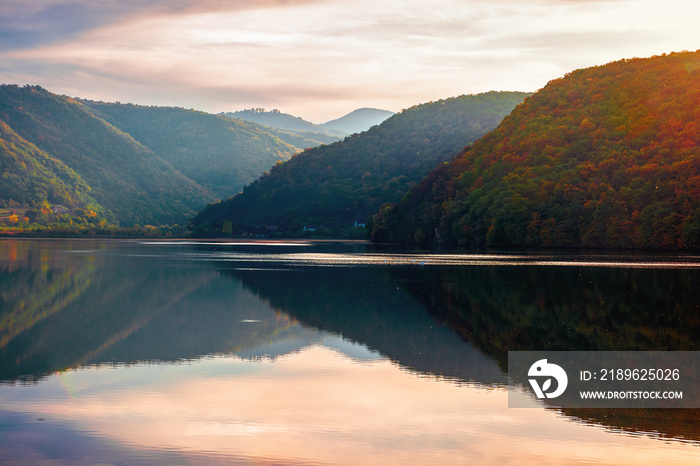 gilau lake of cluj country in evening light. beautiful landscape of romania in autumn. reflection on