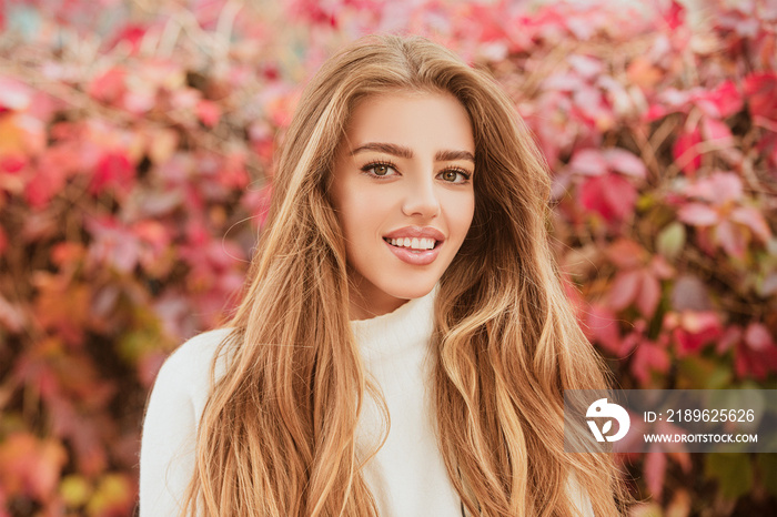 Close up portrait of a Beautiful girl in a white dress near colorful autumn leaves. Pretty tendernes